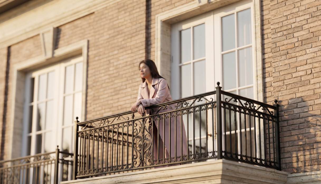 Woman looking out from a Type C balcony
