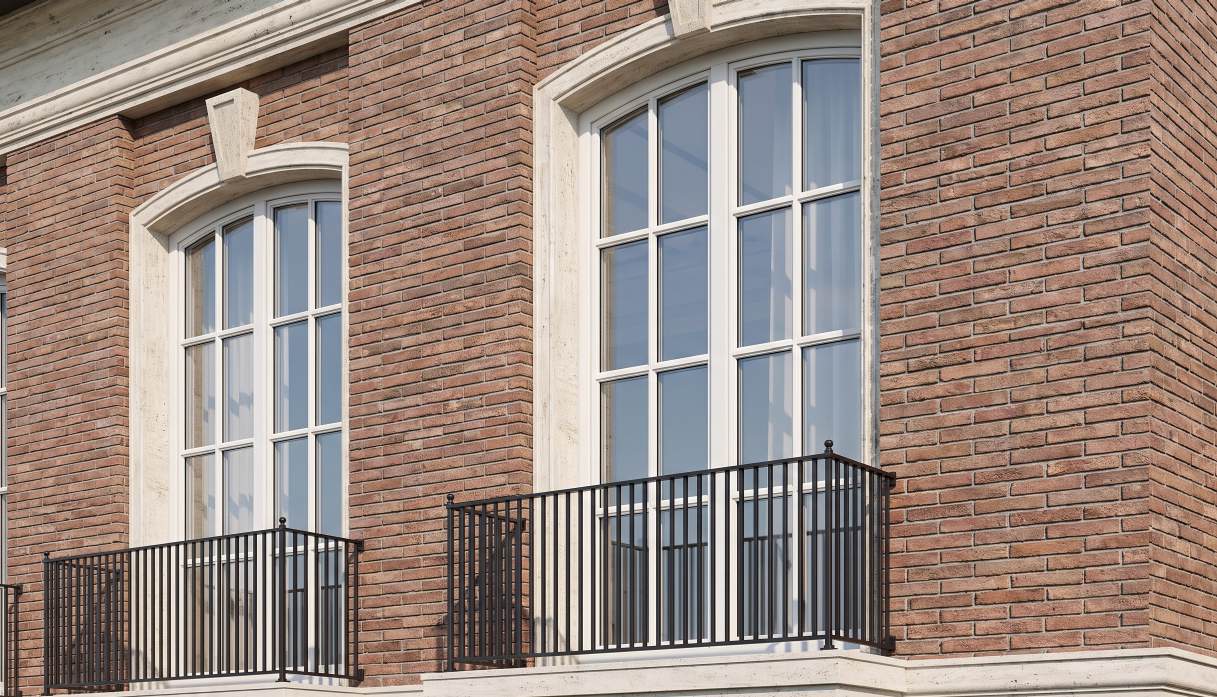 Arched window and black metal railing on the Type B facade